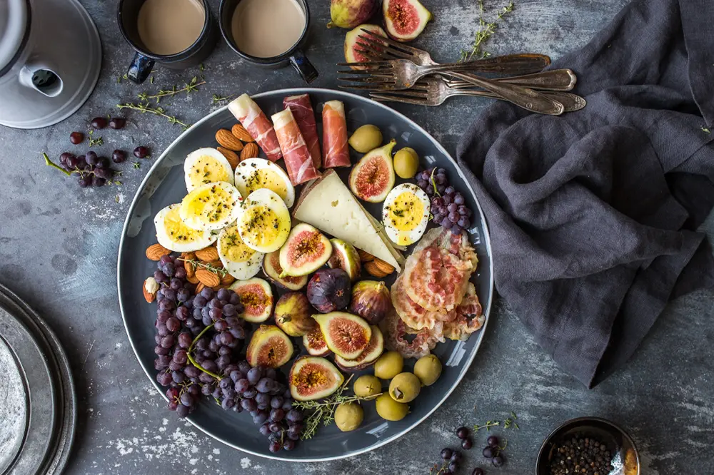 The image shows a plate of foods recommended in the postoperative diet for patients who have undergone gastric sleeve surgery. Learn more about beneficial and necessary food choices during the recovery and adjustment period in our specialized article.